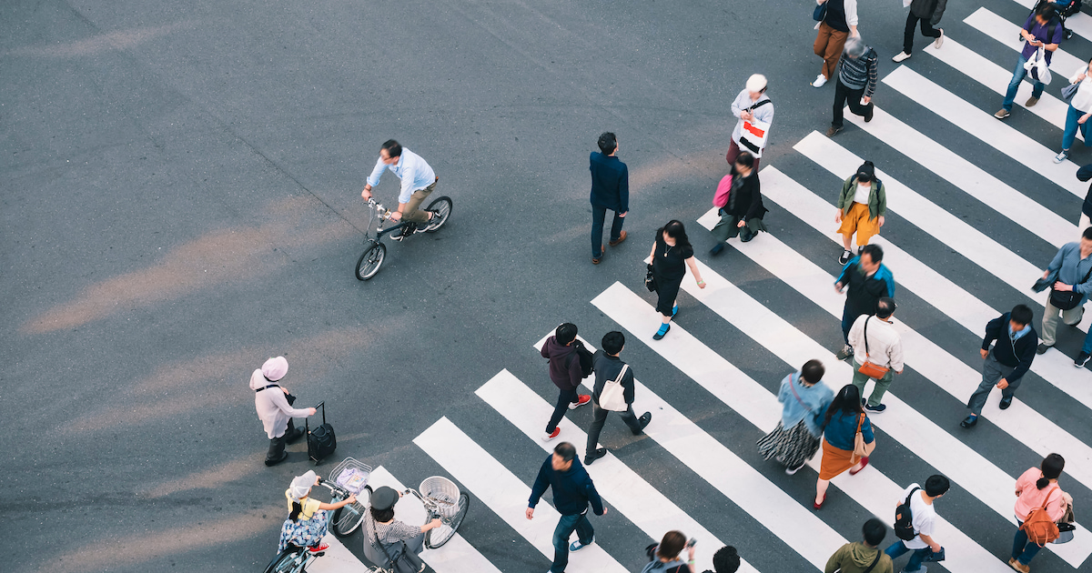 People walking crosswalk in business area in Tokyo, Japan